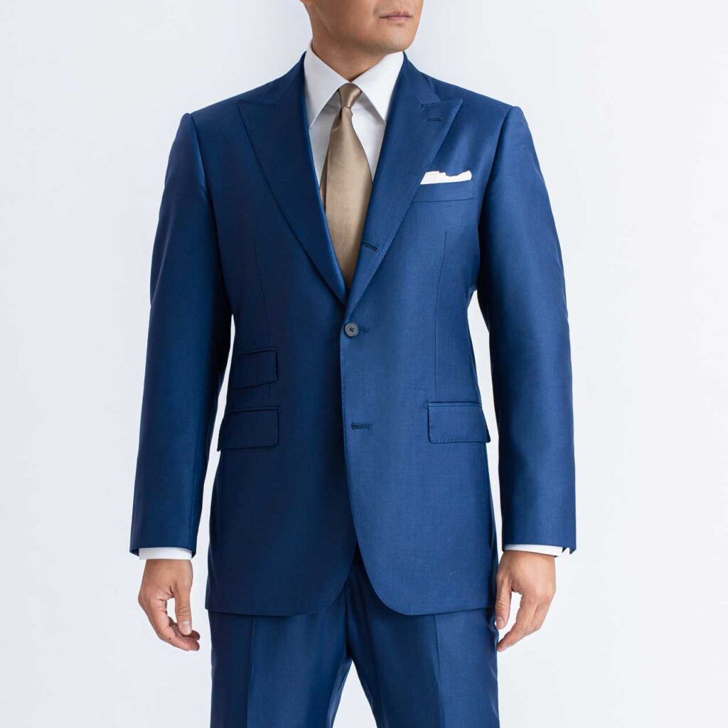 A man in a Royal Blue Blazer, Sharkskin Wool, Super 150's Loro Piana is posing for a photo.