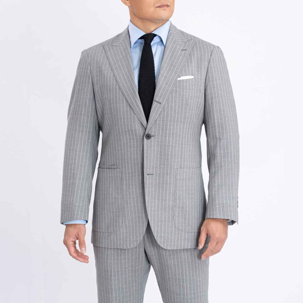 A man wearing a Florence blazer, Grey pinstripes, Super 140's Drago suit and tie.