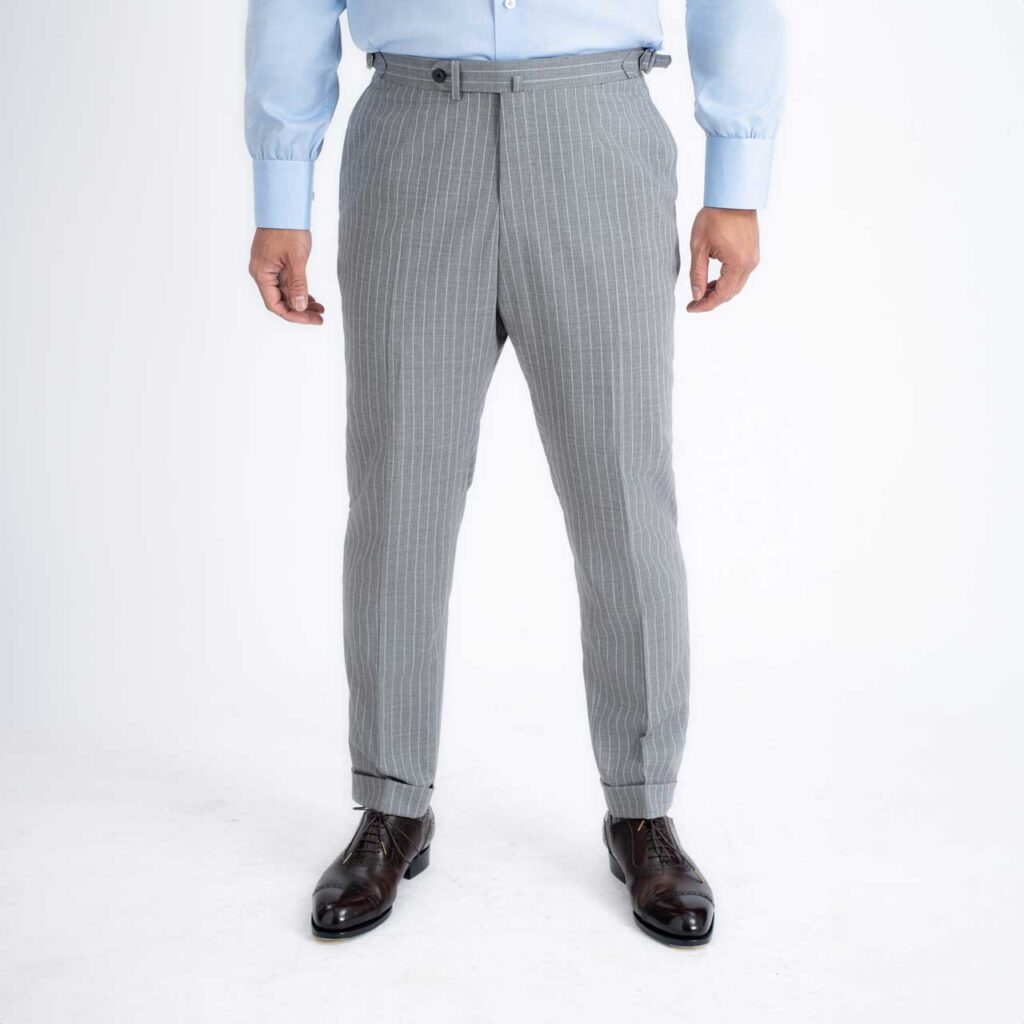 A man wearing a Florence Trouser, Grey pinstripe wool Super 140's, Drago suit and trousers.