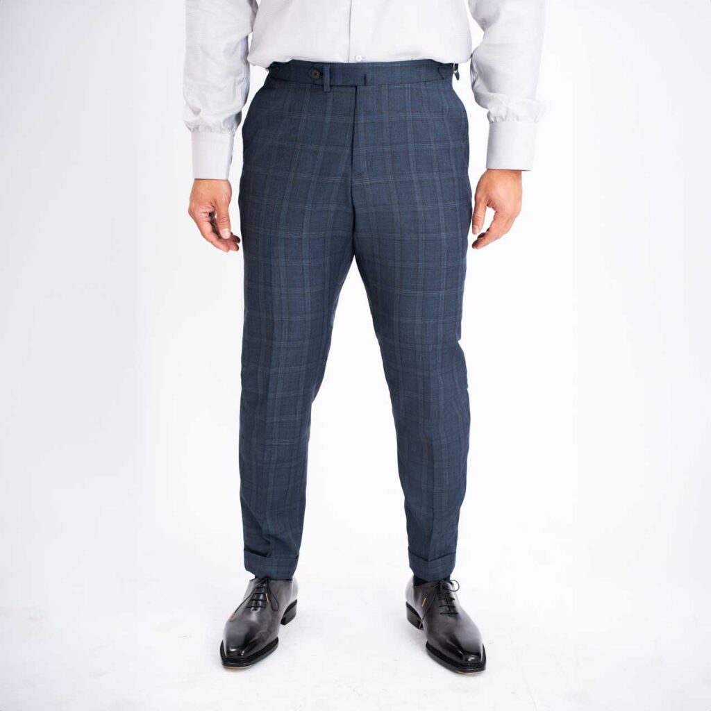 A man wearing a Blue Check Wool Trouser, Super 130's, Reda suit.