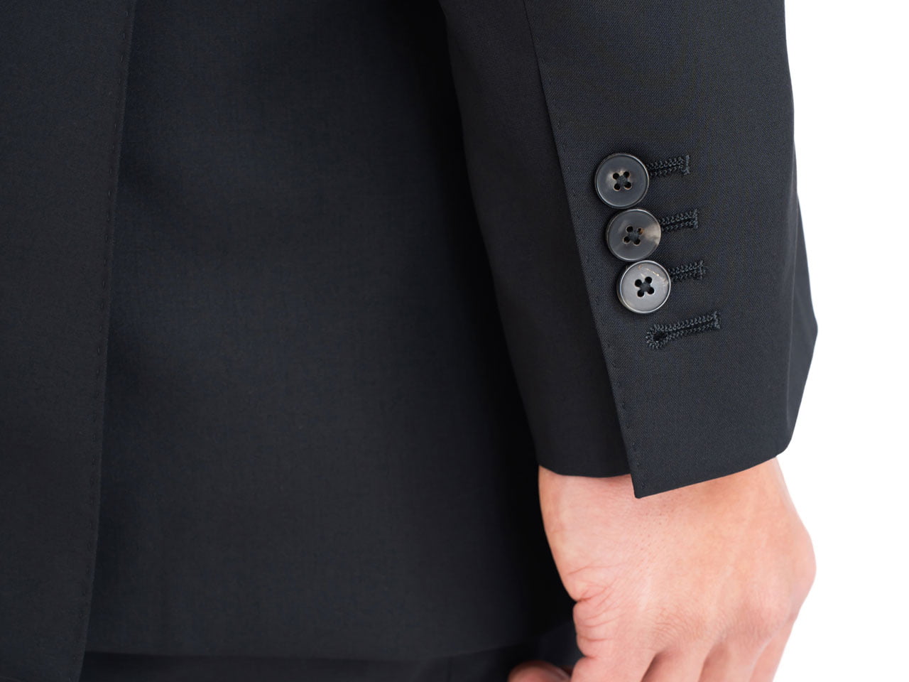 A close up of a man's hand in a Black Suit, Super 120's Wool, Vitale Barberis.