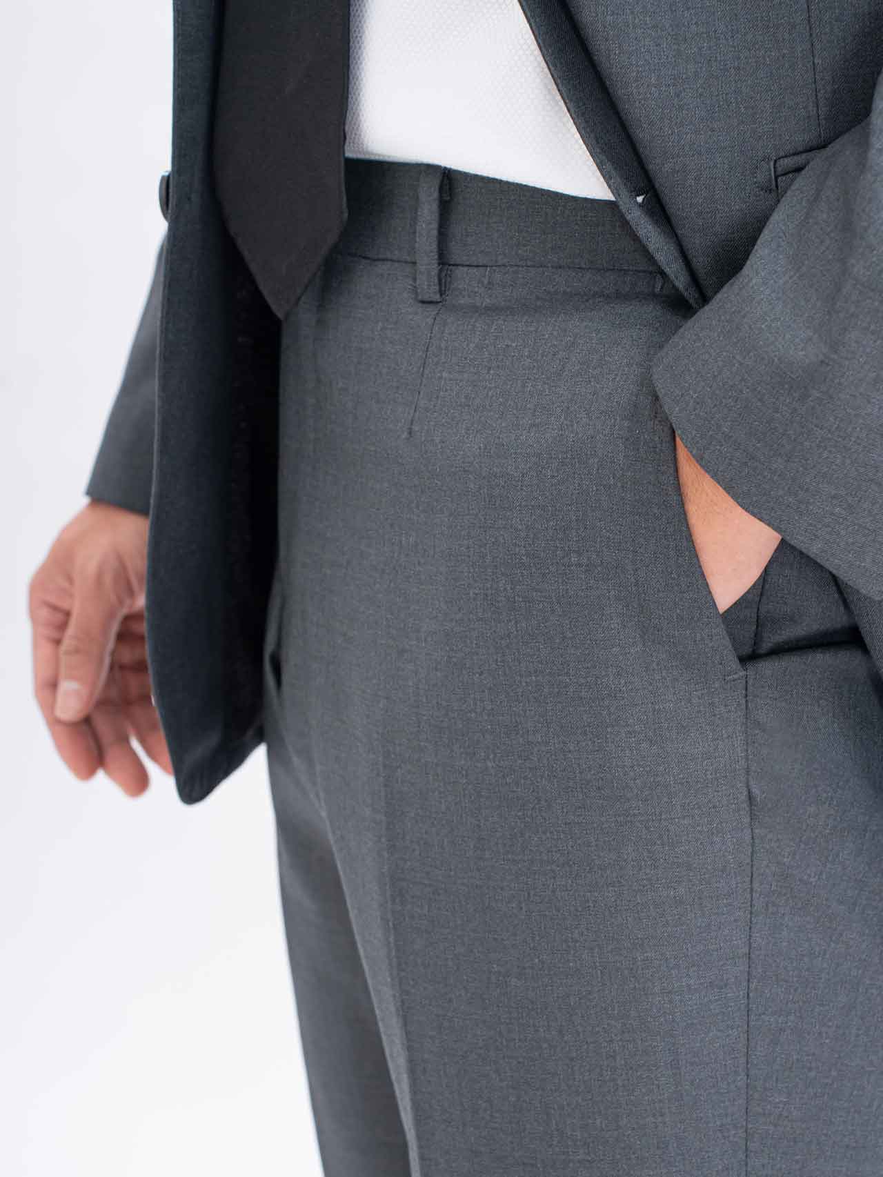 A man in a Grey Suit, Australian Wool, Super 150's with his pocket open.