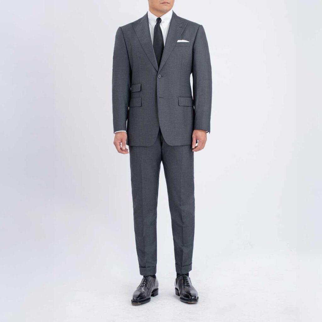 A man in a Grey Australian wool suit, Super 150's Loro Piana, is standing in front of a white background.