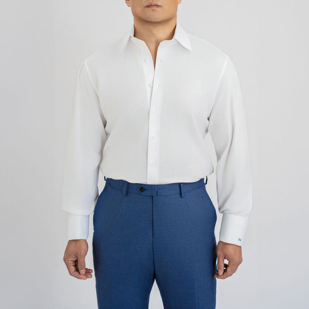 A man wearing a white shirt, collar TF88, Cotton 100s with a cut away collar.