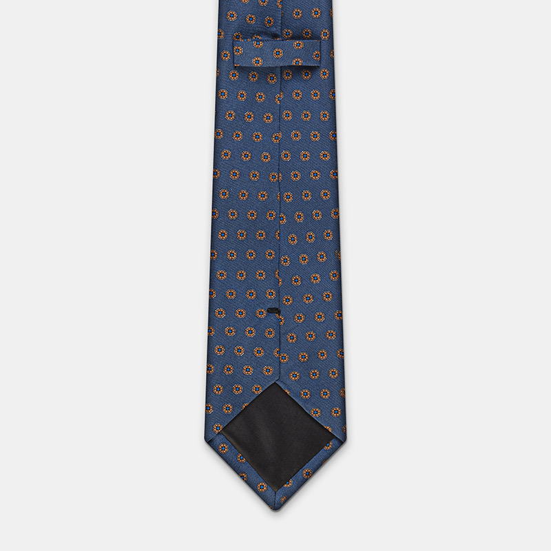 Blue necktie with orange floral patterns and a black tipping, ideal for pairing with a Pompeï white ceremony shirt, cotton 80s.