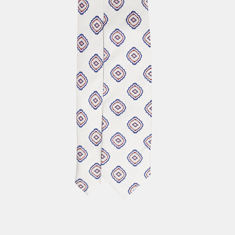 Elegant patterned necktie on a white background.