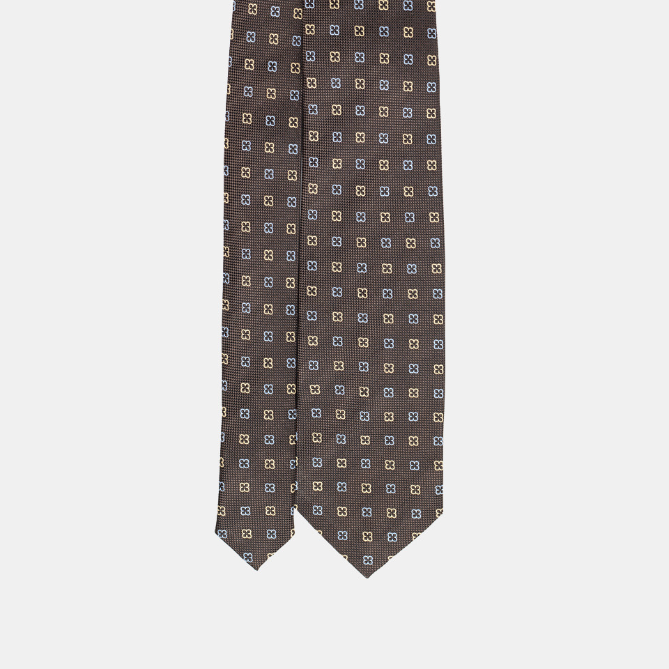 Patterned necktie on a white background.