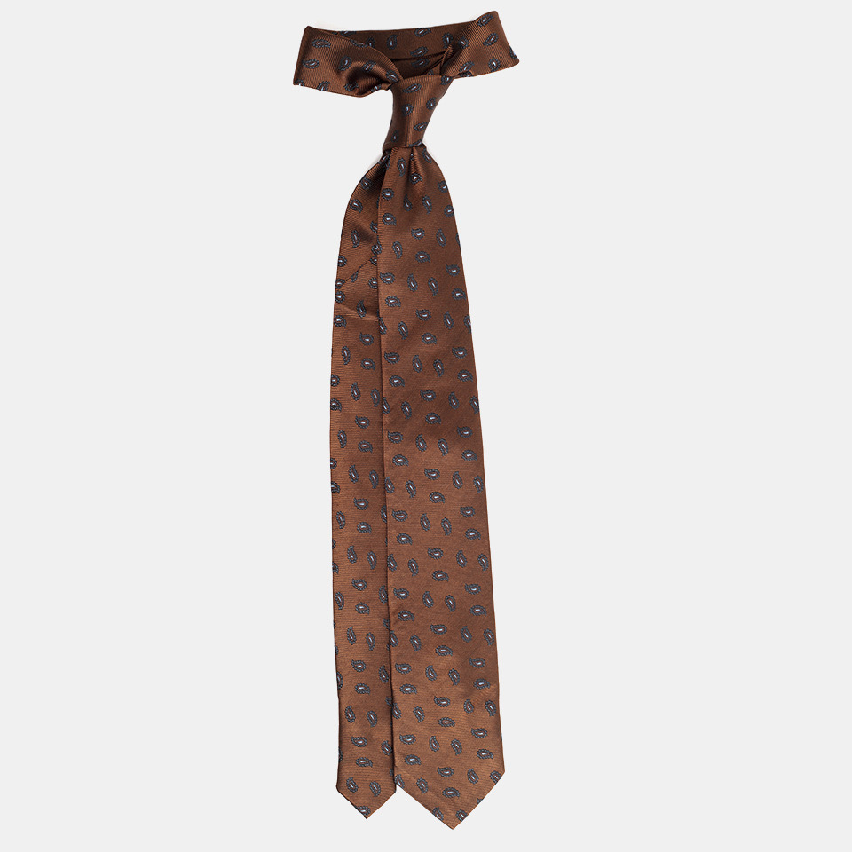 A brown necktie with paisley pattern isolated on a white background.