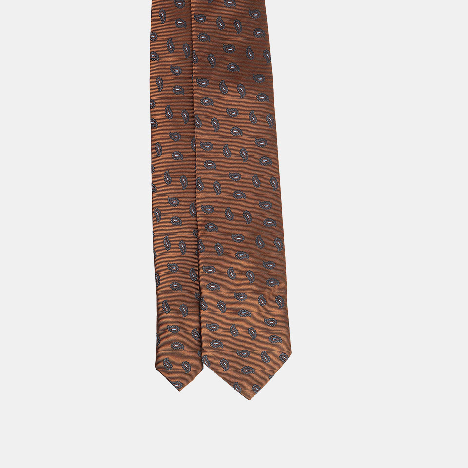 Patterned brown necktie against a white background.