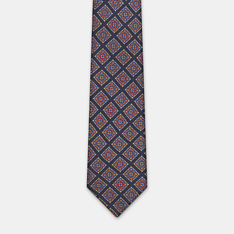 A silk tie, n°137 with geometric shapes on a solid white background.