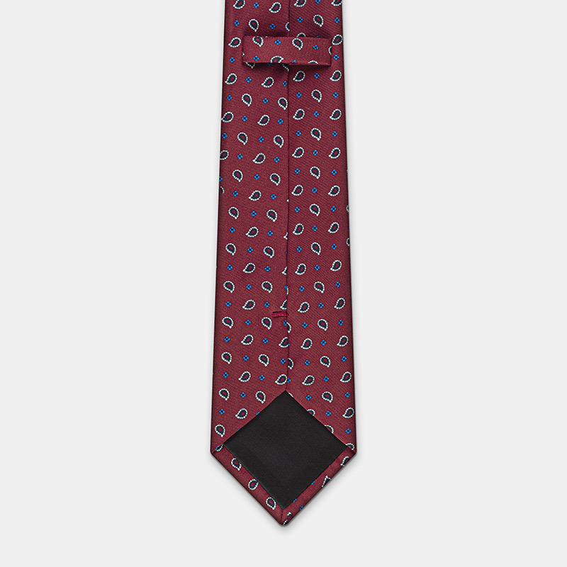 A red silk tie with blue and white patterns on a white ceremony shirt, n°137.