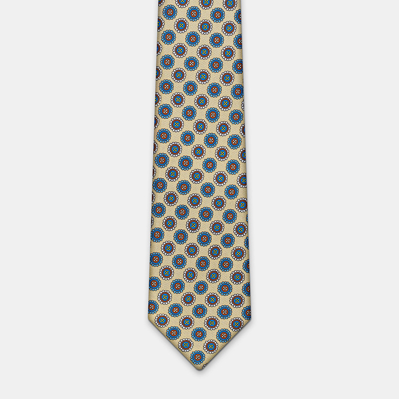 Silk tie n°137 with circular red and gold pattern design on a white ceremony shirt background.