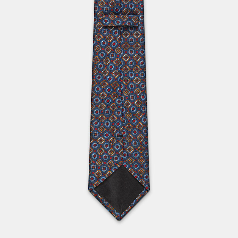 Blue silk tie with flowers, n°137 with geometric design on a white ceremony shirt.