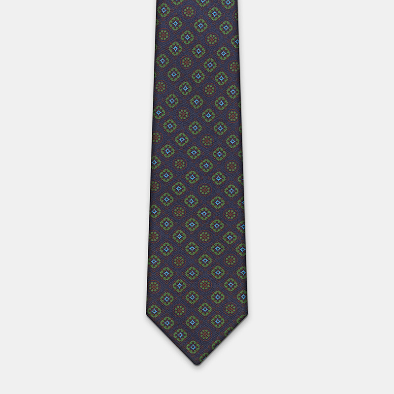 Blue silk tie with flowers, n°137 with geometric pattern design, paired with a white ceremony shirt.
