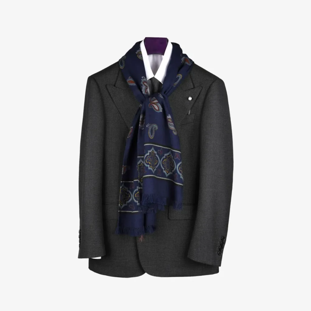 A dark gray blazer displayed on a hanger, accented with the Fidema wool and silk scarf in deep plum, elegantly draped around the collar.