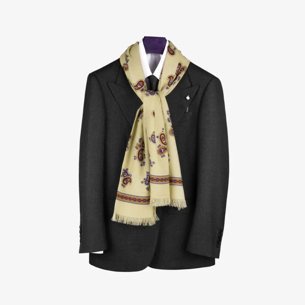 A dark gray suit jacket on a hanger, elegantly styled with the Fidema wool and silk scarf in light grey, its pattern tastefully draped around the collar.