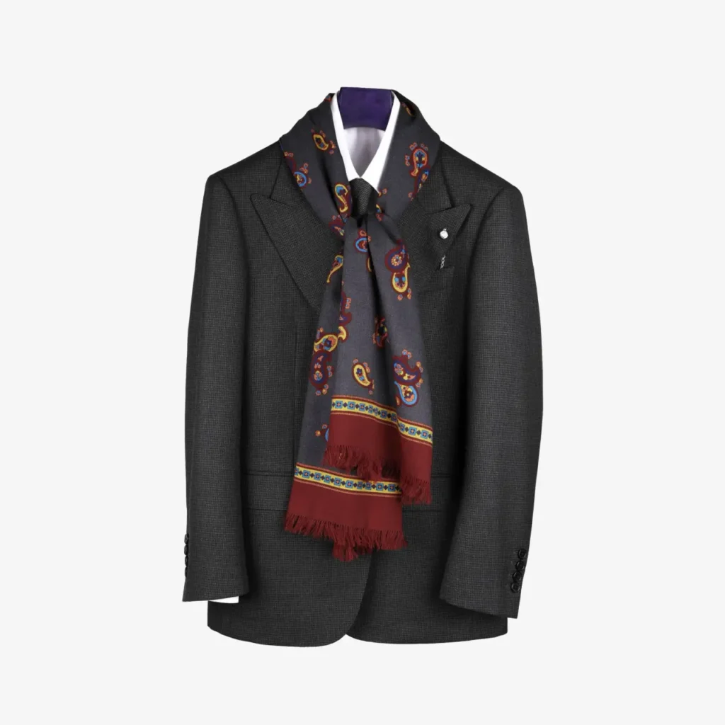 A dark gray suit jacket on a hanger with a white shirt, accessorized with the Fidema light grey wool and silk scarf draped around the collar.
