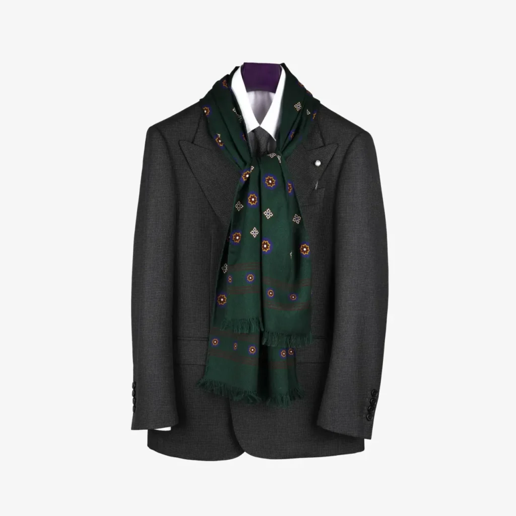 A dark gray suit jacket and white shirt on a hanger, accented by the Lunema wool and silk scarf in Midnight blue, stylishly draped around the collar.