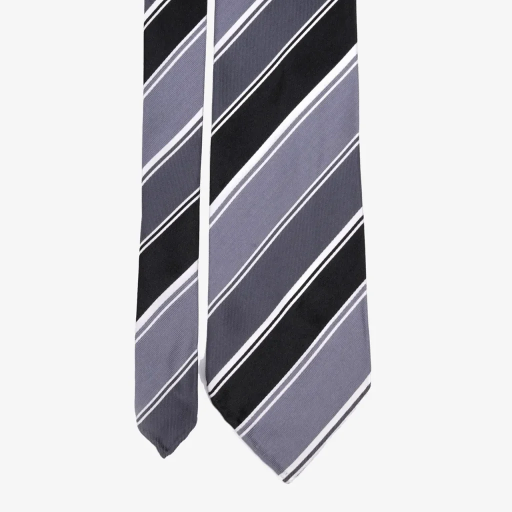 A close-up of the Abstract medallions silk tie in olive green, featuring an intricate pattern, displayed on a white background.
