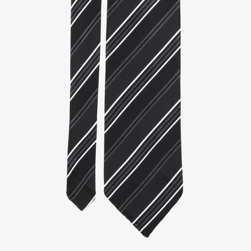 A close-up of the Wide stripes silk tie – Blue and brown, showcasing its stylish blue fabric with bold diagonal brown stripes against a plain background.