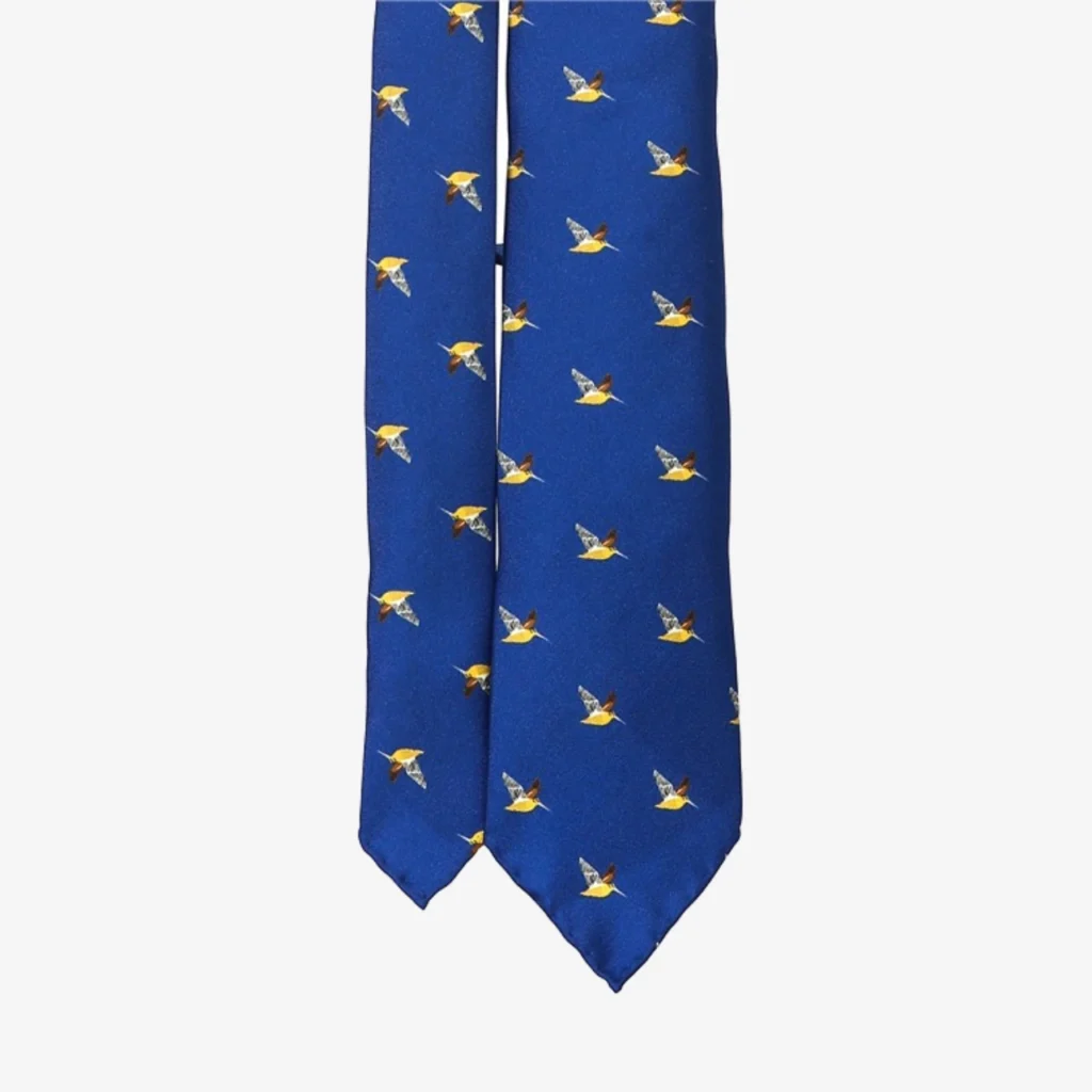 A blue silk tie with a geometric floral pattern.